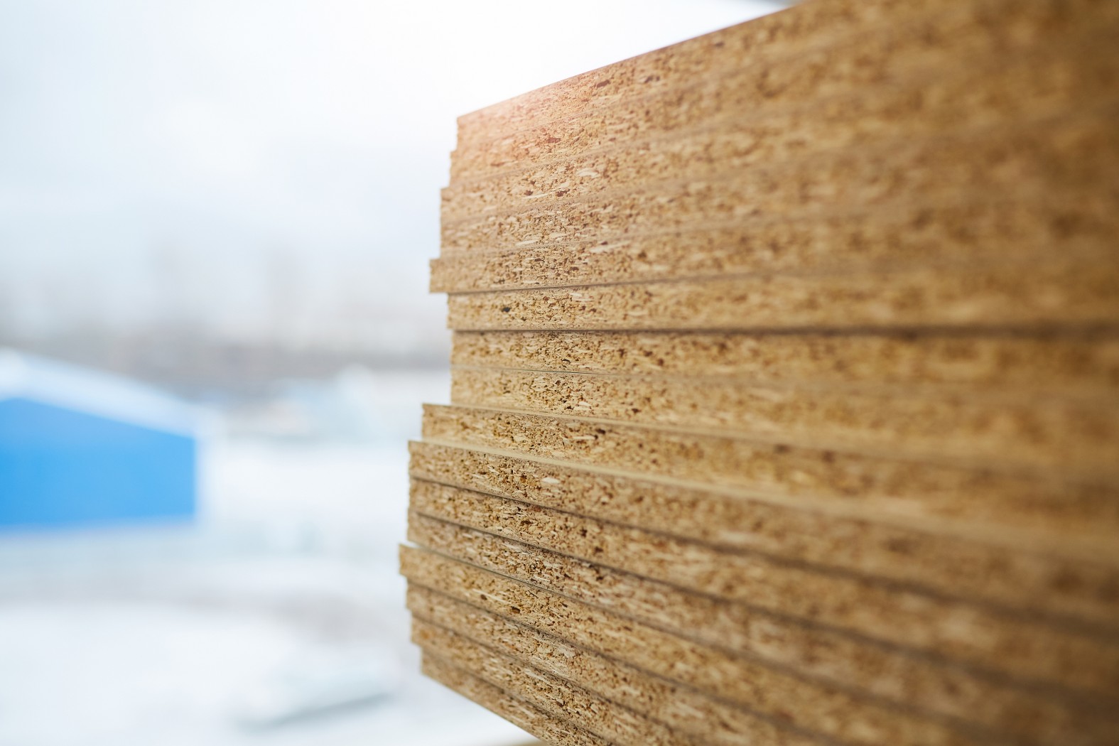 Close-up of wood particle boards on the table in workshop